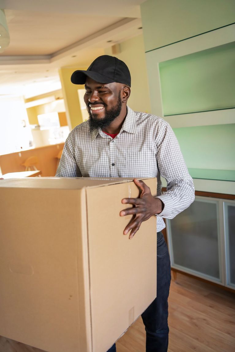 Happy man moving packages — Monroe, LA — Ross Movers, Inc.
