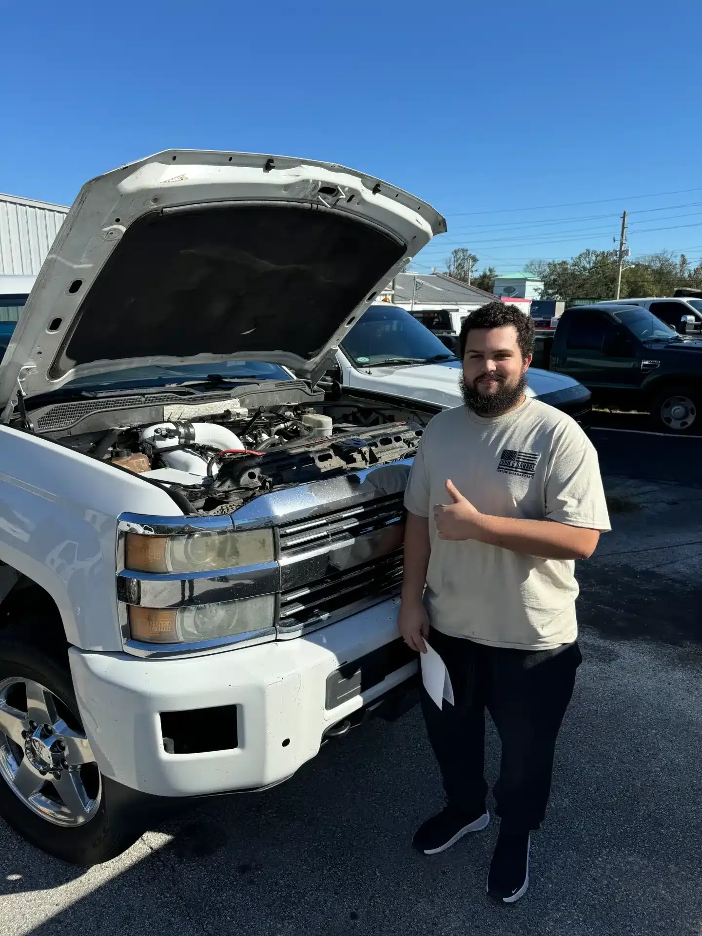White Truck with hood up, staff member in front | DMR Diesel Repair, Inc