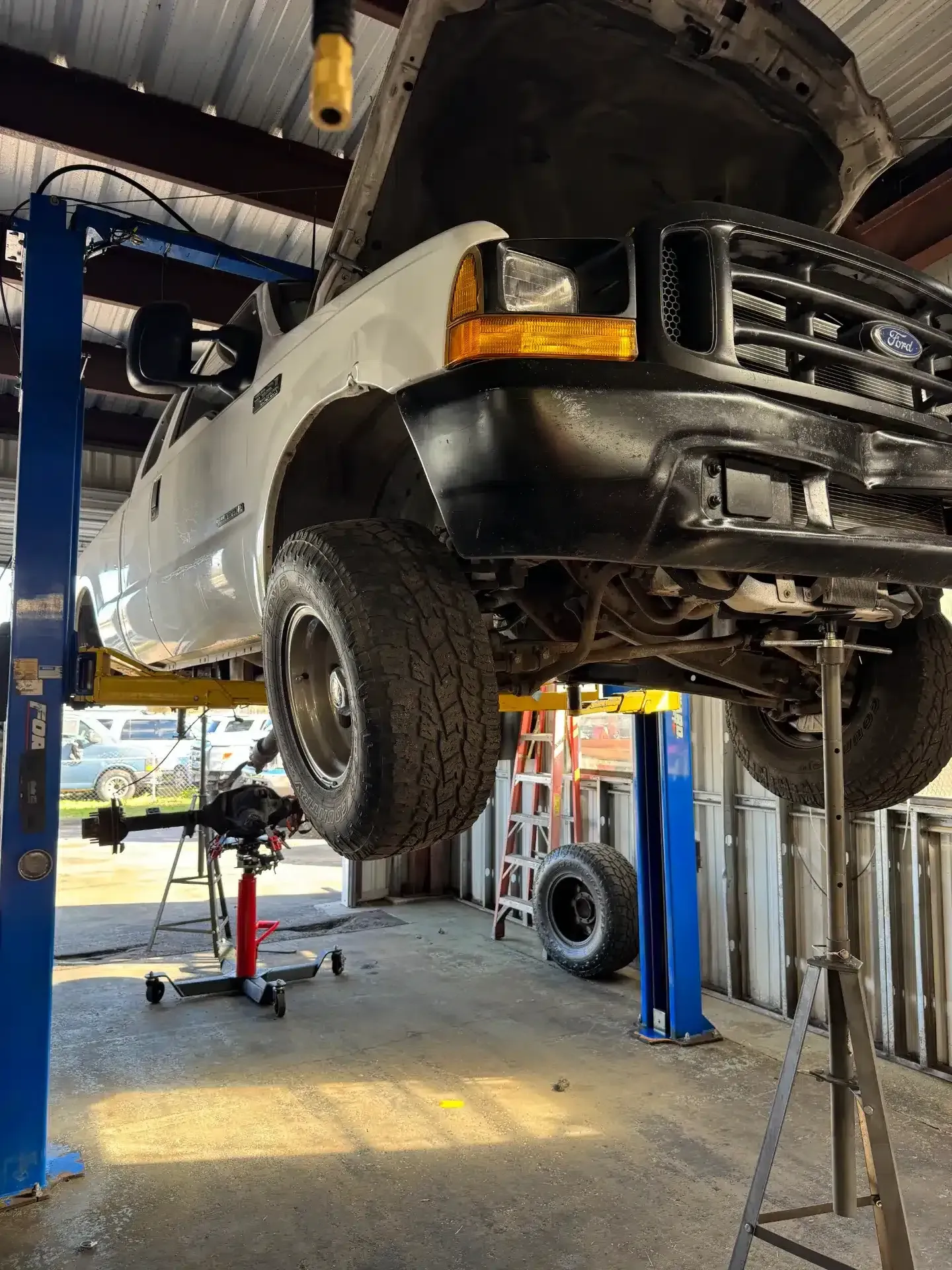White Truck Raised in Garage | DMR Diesel Repair, Inc