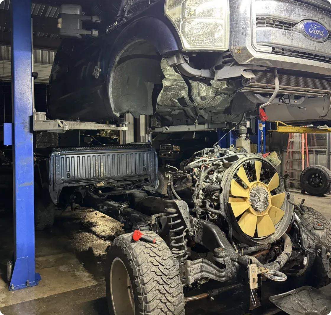 Blue Ford truck in repair | DMR Diesel Repair, Inc