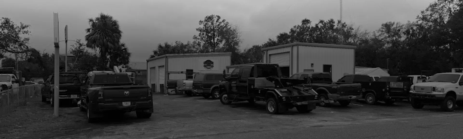 Black and white vehicles parked outside | DMR Diesel Repair, Inc