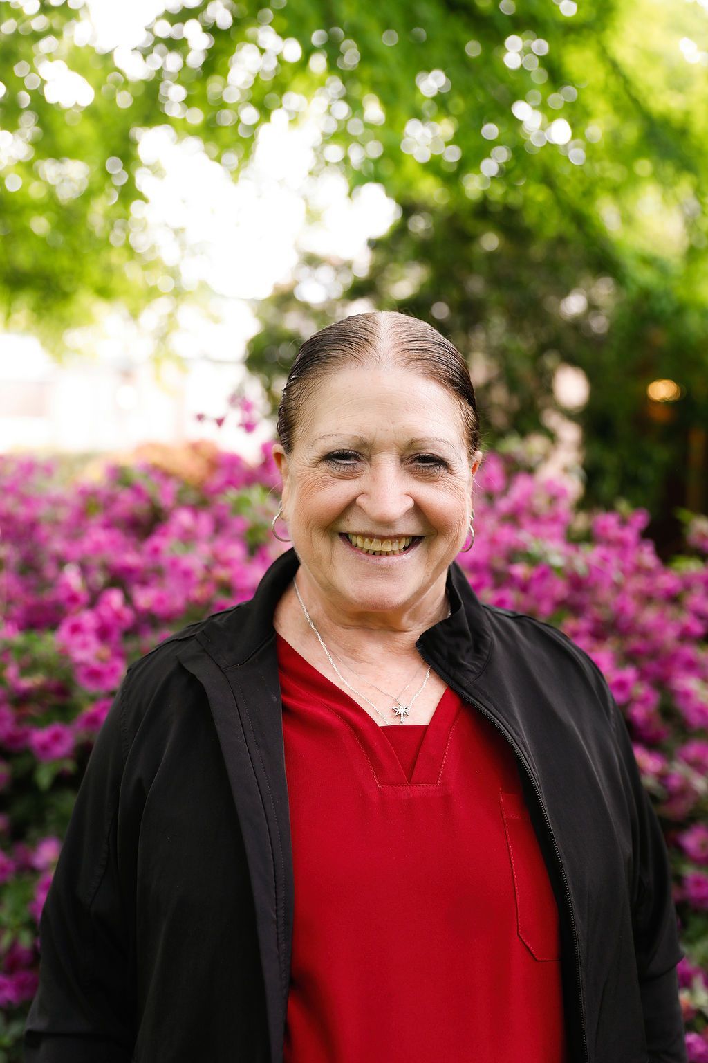 A woman wearing a yellow beret is looking through binoculars