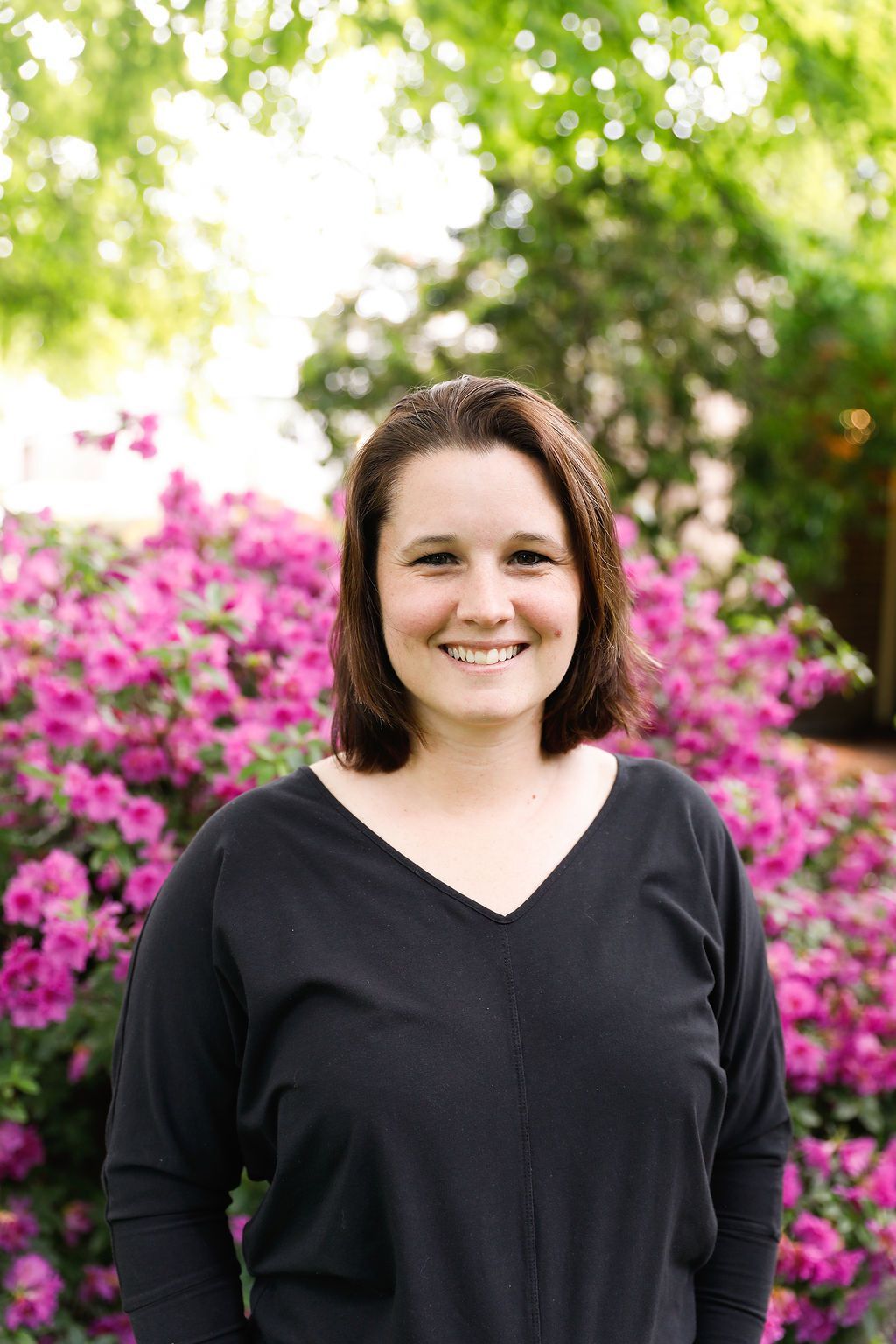A young man is holding a yellow television in his hands.