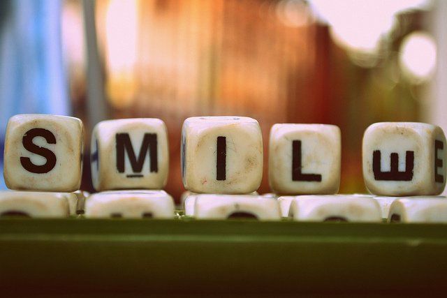 A bunch of dice with the word smile written on them