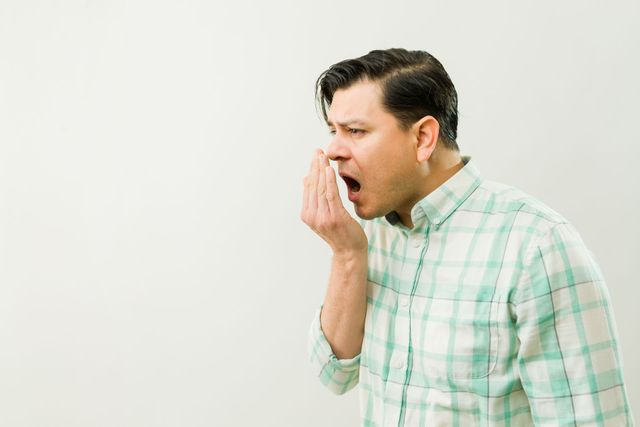 https://lirp.cdn-website.com/bb892343/dms3rep/multi/opt/stock-photo-profile-of-a-latin-man-covering-his-mouth-with-his-hand-while-exhaling-to-assess-his-breath-2608300207-640w.jpg