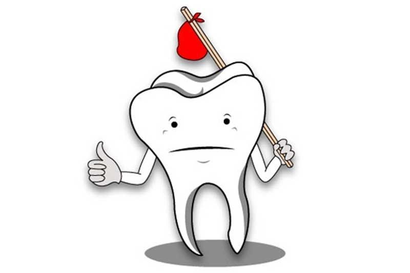 A tooth is holding a hammer and giving a thumbs up.