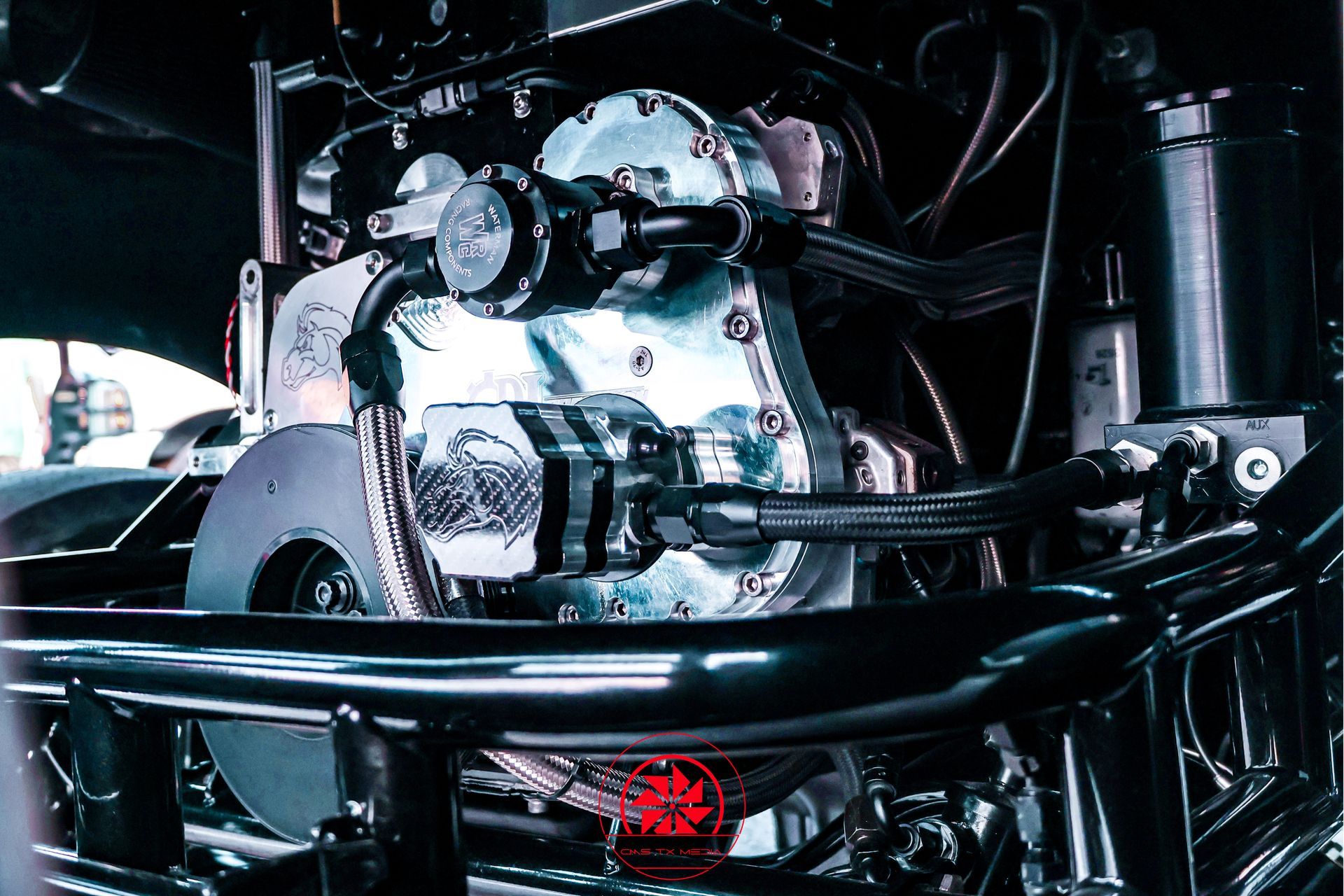 Chrome car engine with turbocharger and hoses in a dark engine bay