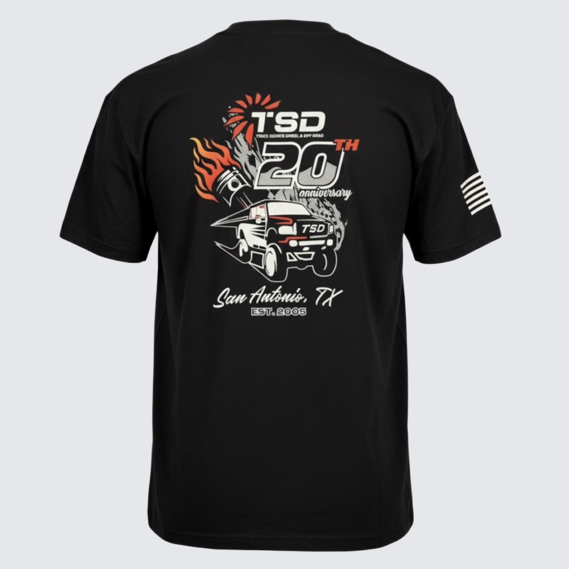Black T-shirt with TSD 20th anniversary graphic in white and orange on the back, featuring a truck and flames.