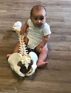 Baby holding skeleton - pediatric care in Bonita Springs, FL
