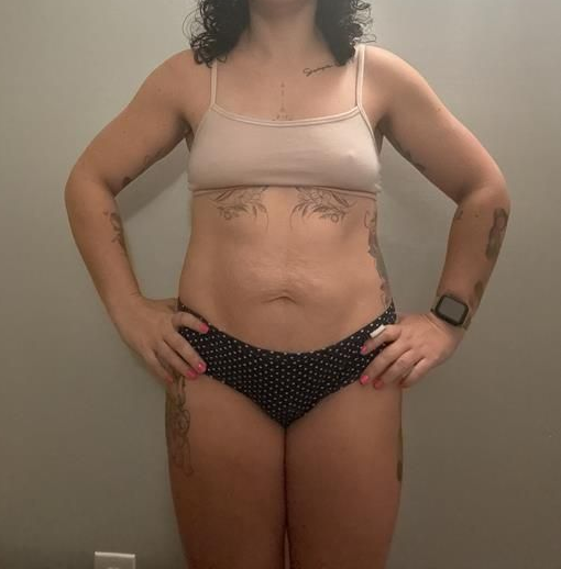 Person standing, wearing a light tan bra and polka dot underwear. Hands on hips.