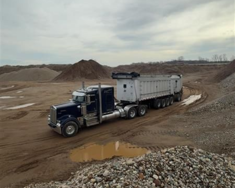 Excavator moving sand 
