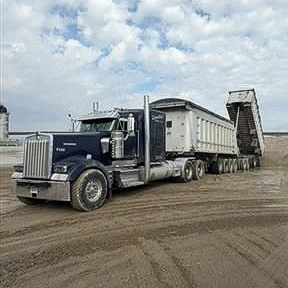 dump truck shown in a highway area with new asphalt