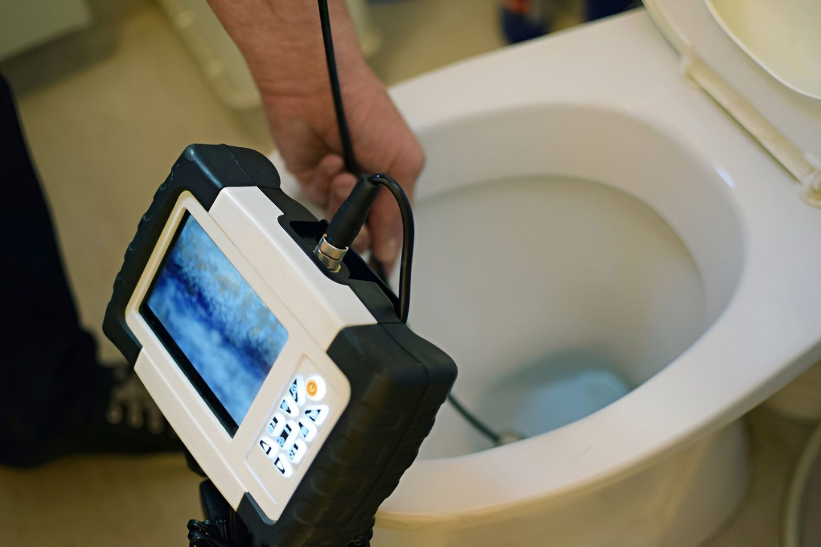 Checking Clogged Toilet Pipe With Inspection Camera — Dunnrite Plumbing Services Cannonvale in Cannonvale, QLD