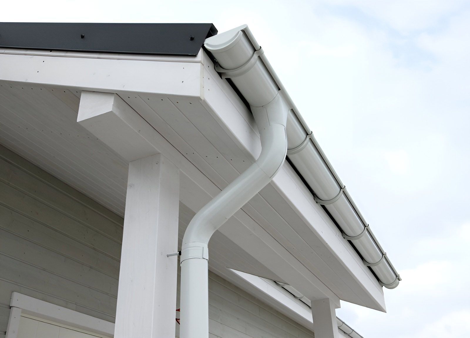A White Gutter On The Roof Of A House — Dunnrite Plumbing Services Cannonvale in Cannonvale, QLD