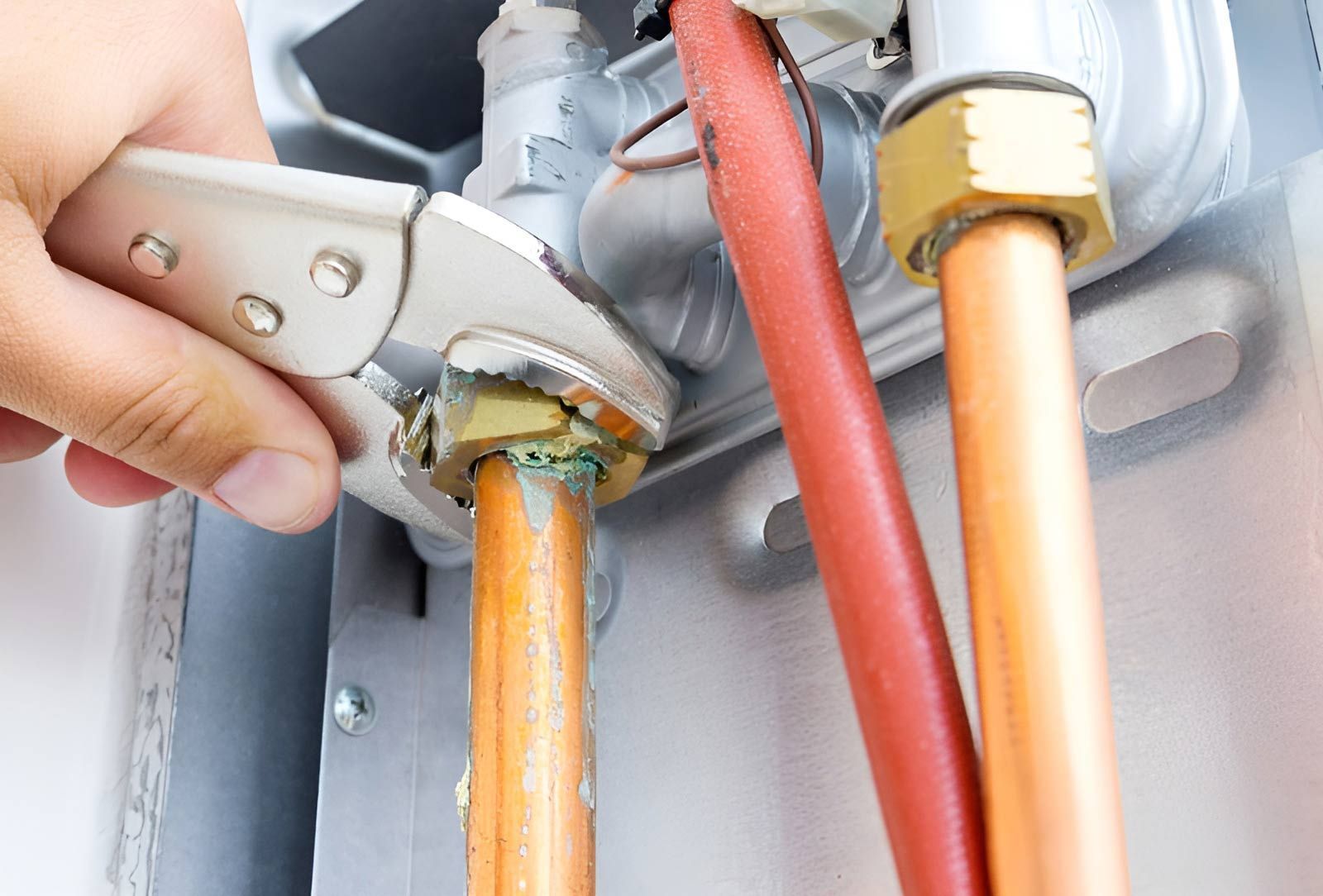 Plumber With Wrench Fixing The Broken Pipe — Dunnrite Plumbing Services Cannonvale in Proserpine, QLD