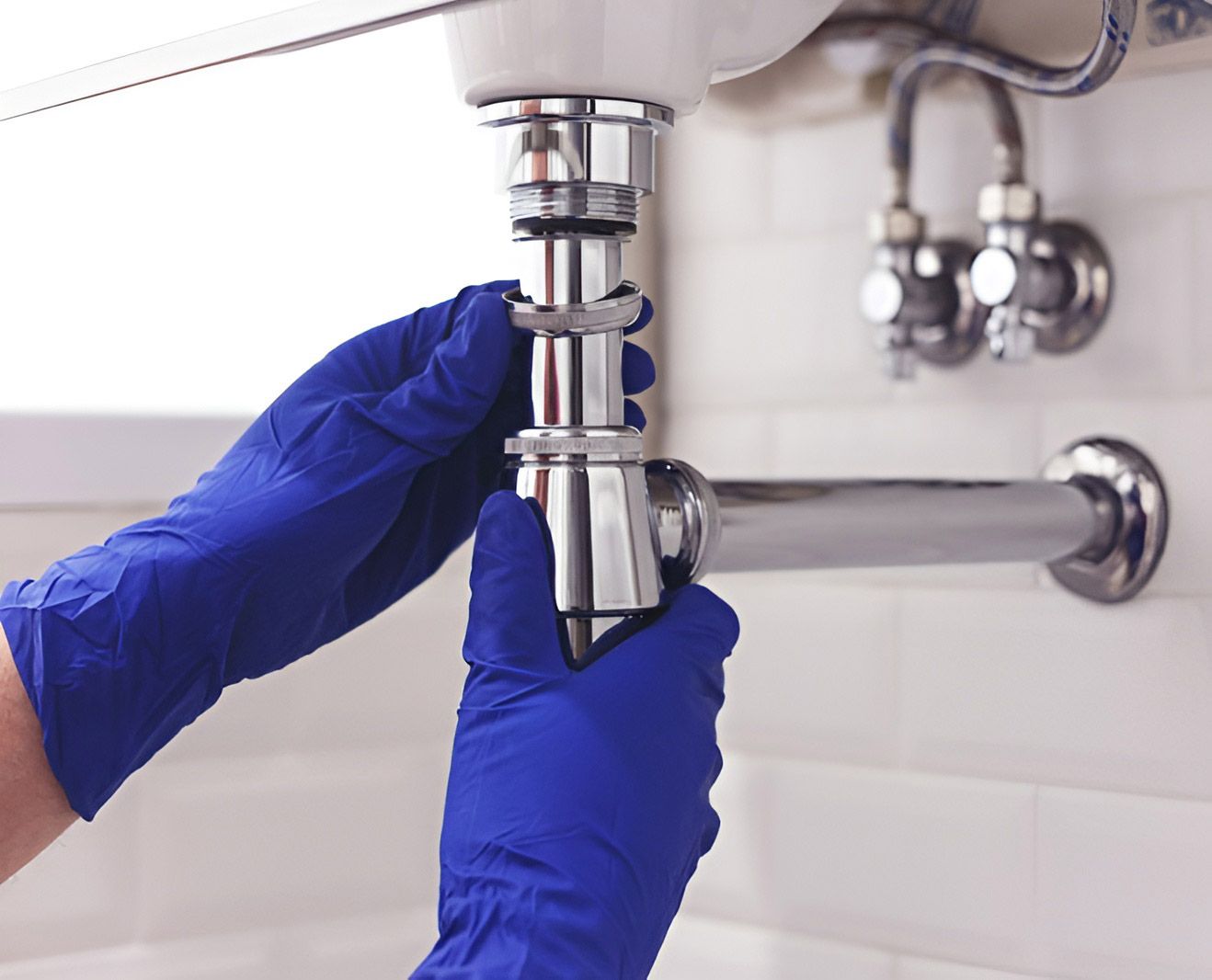 Plumber Repairs And Maintains Chrome Siphon Under The Washbasin — Dunnrite Plumbing Services Cannonvale in Cannonvale, QLD