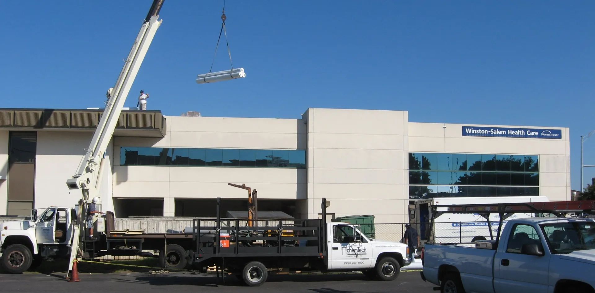 Using a crane to put supplies on a roof