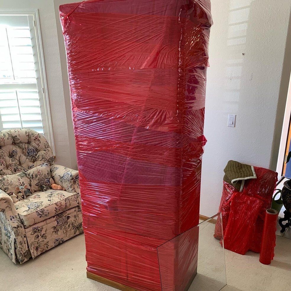 Sofa Wrapped in Red Plastic — Denver, CO — RnB Movers LLC