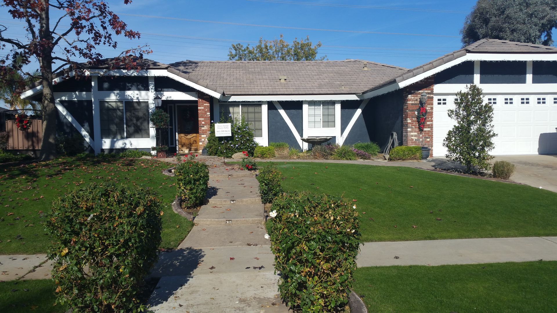 A house with a lawn and a walkway leading to it