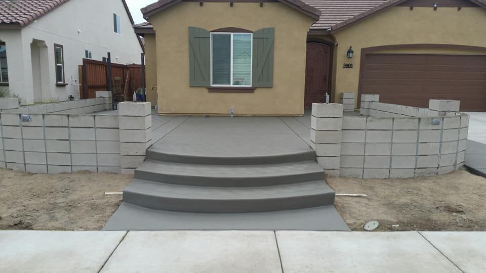 A house with concrete steps leading up to it