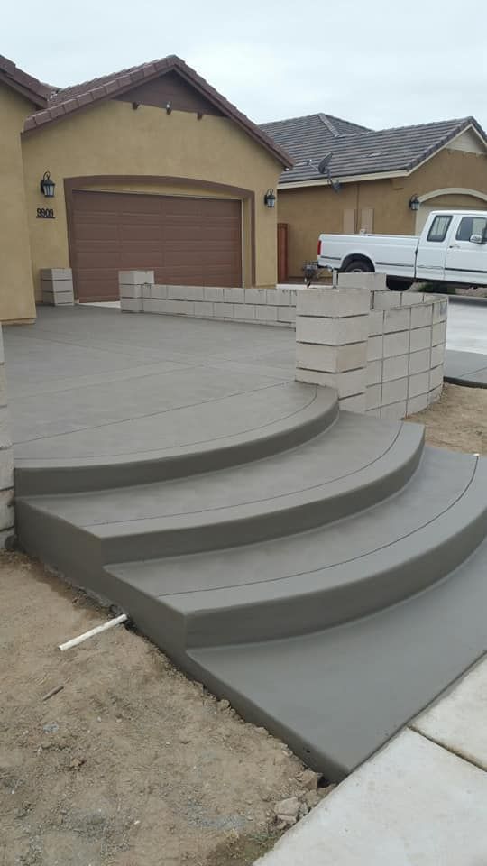A set of concrete steps leading up to a house.