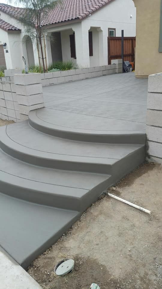 A set of concrete steps leading up to a house.