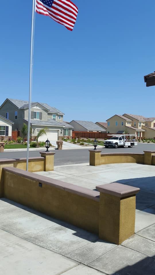 An american flag is flying in front of a residential area