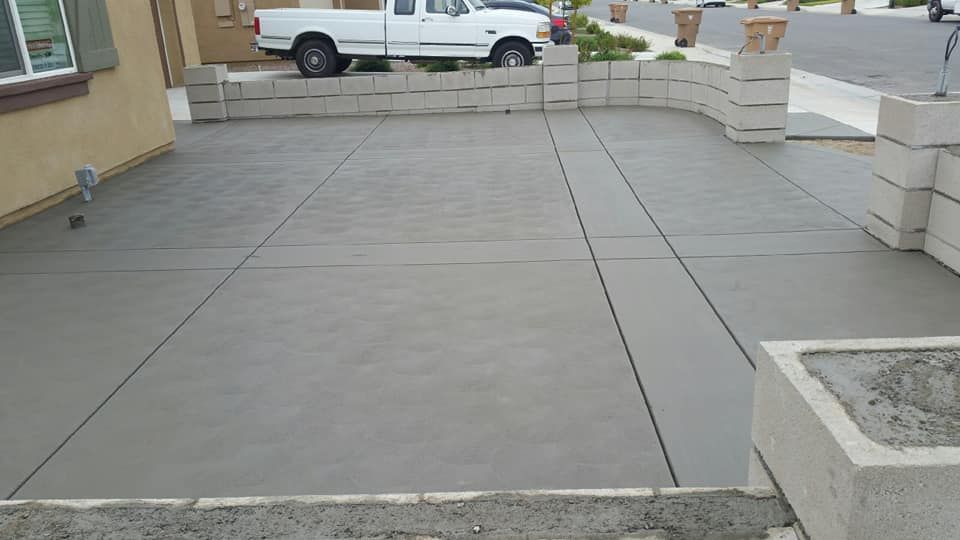 A white truck is parked in a driveway next to a house.