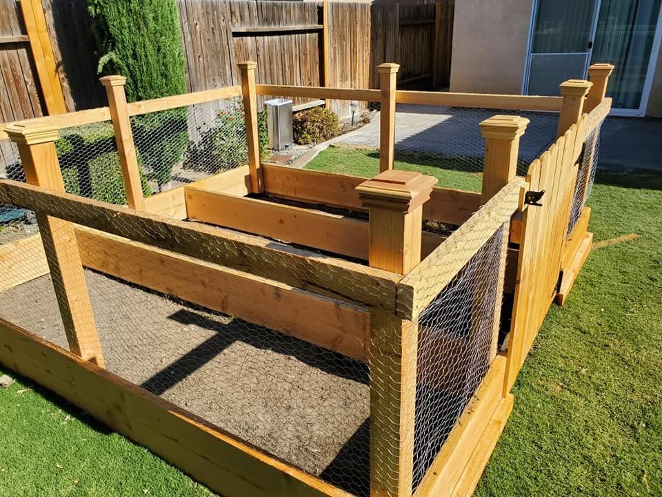 A wooden fence is sitting on top of a lush green lawn.