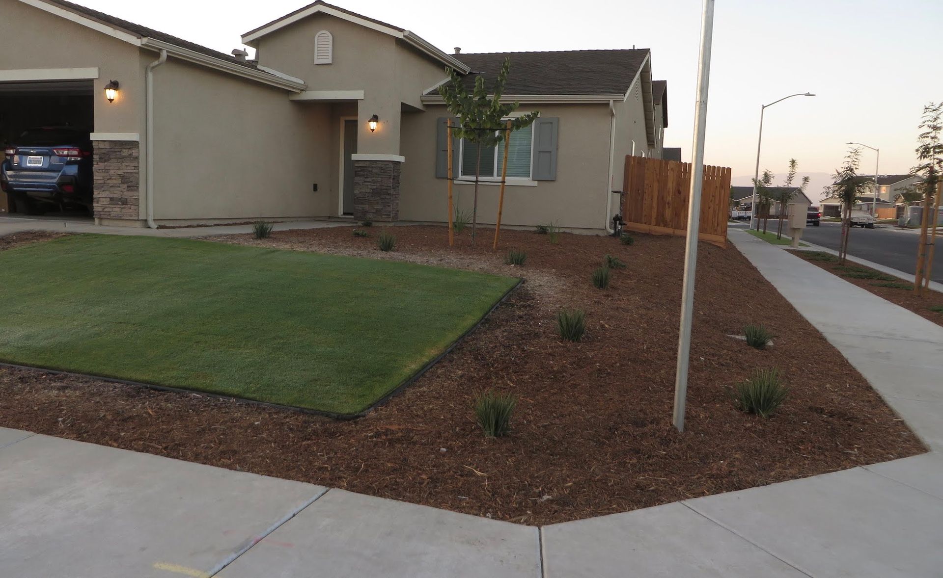 A car is parked in a garage in front of a house