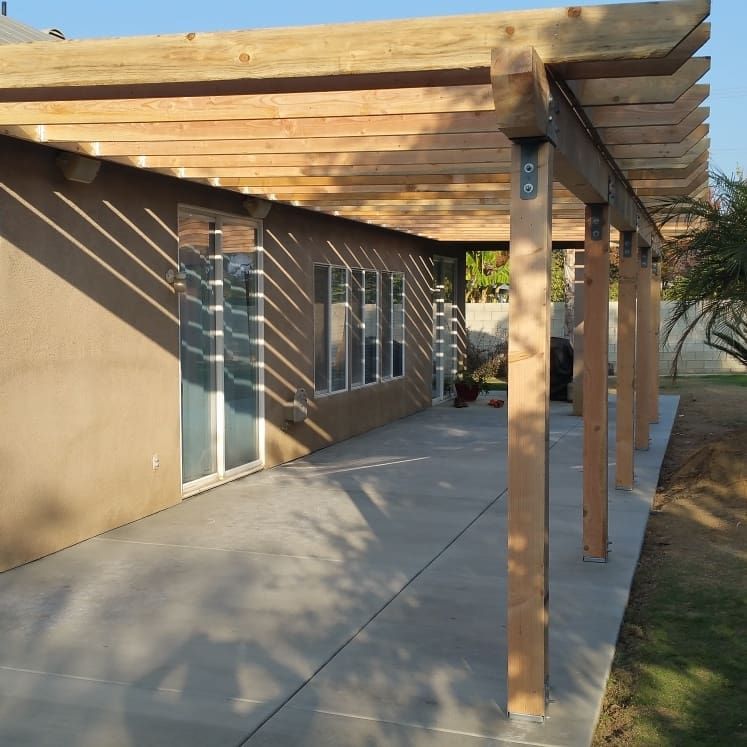 A house with a wooden pergola over the patio
