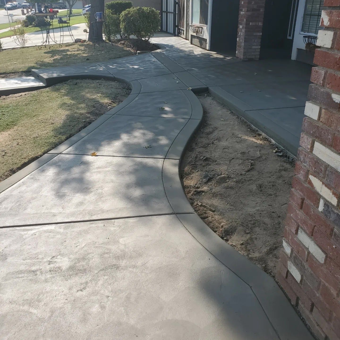 A brick building with a concrete walkway leading to it