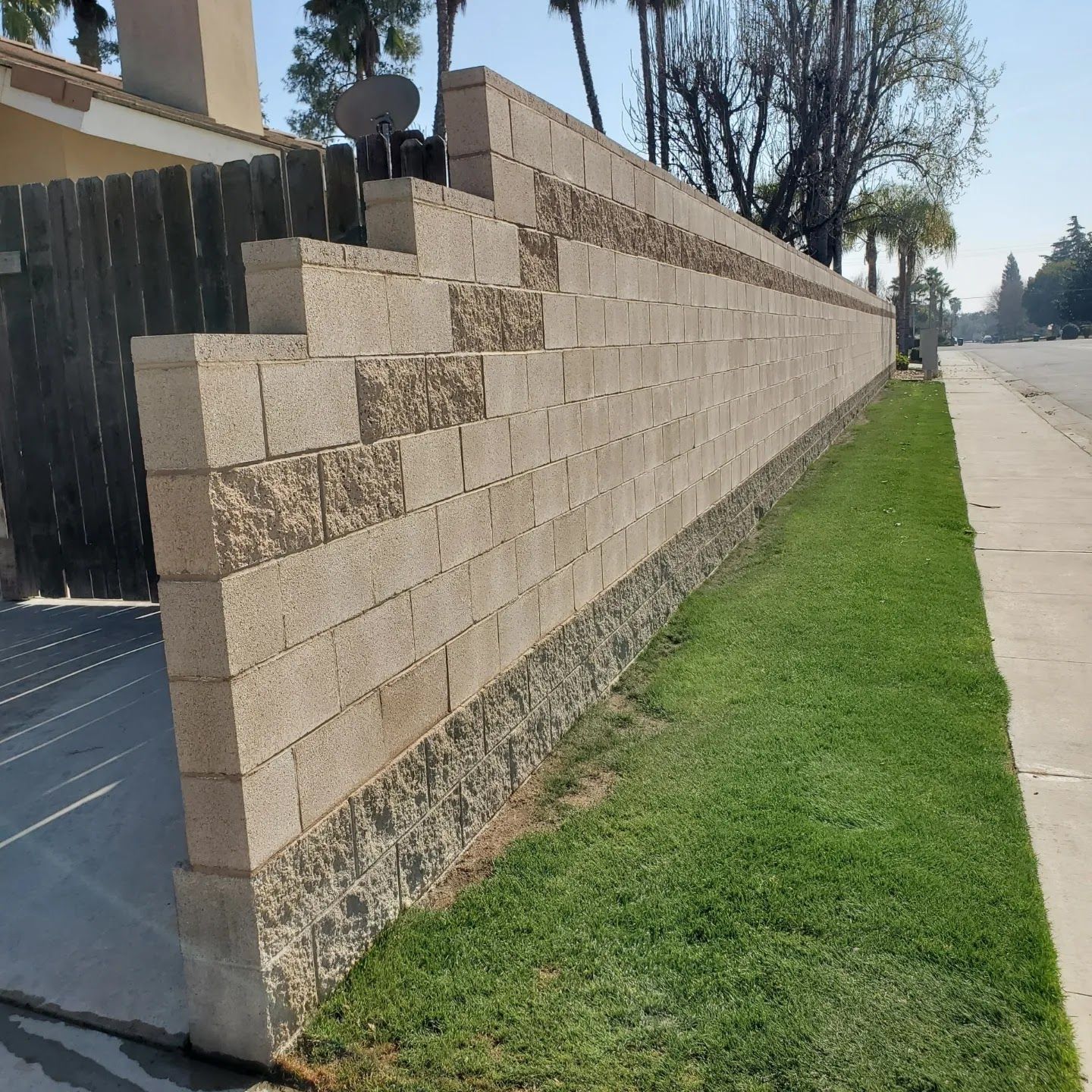 A large brick wall along the side of a road