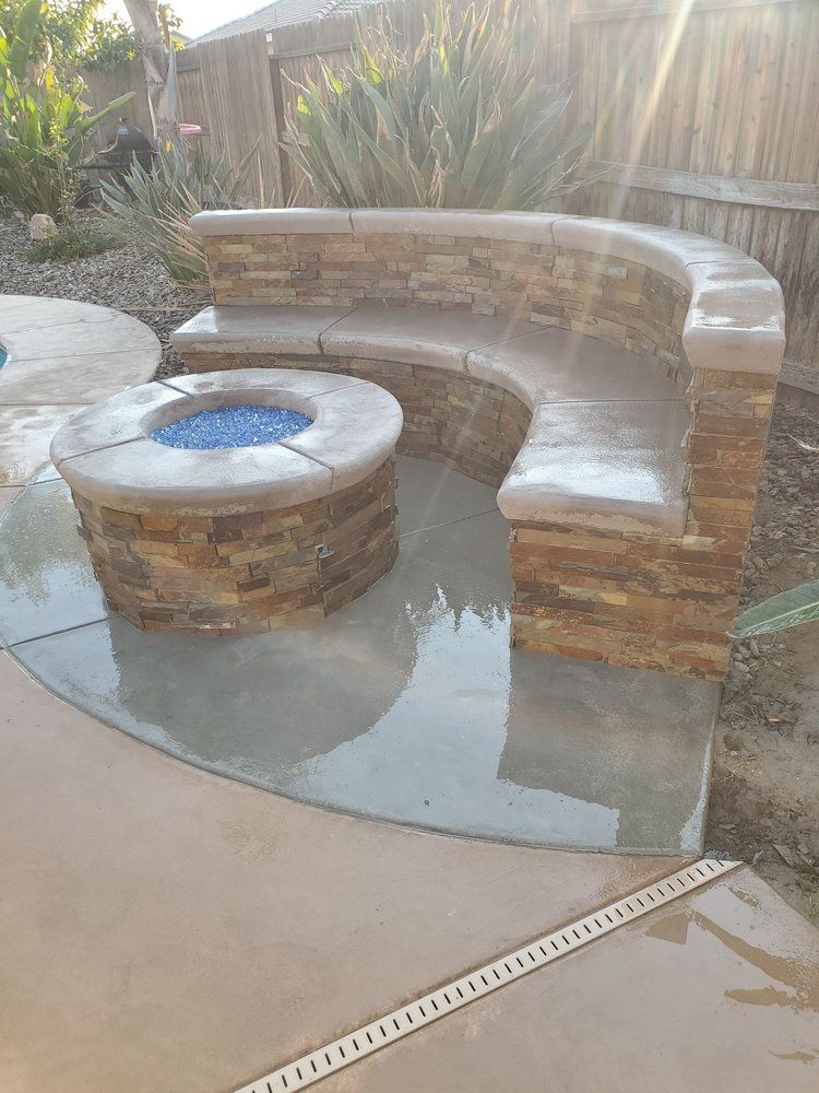 There is a fire pit with a bench around it.