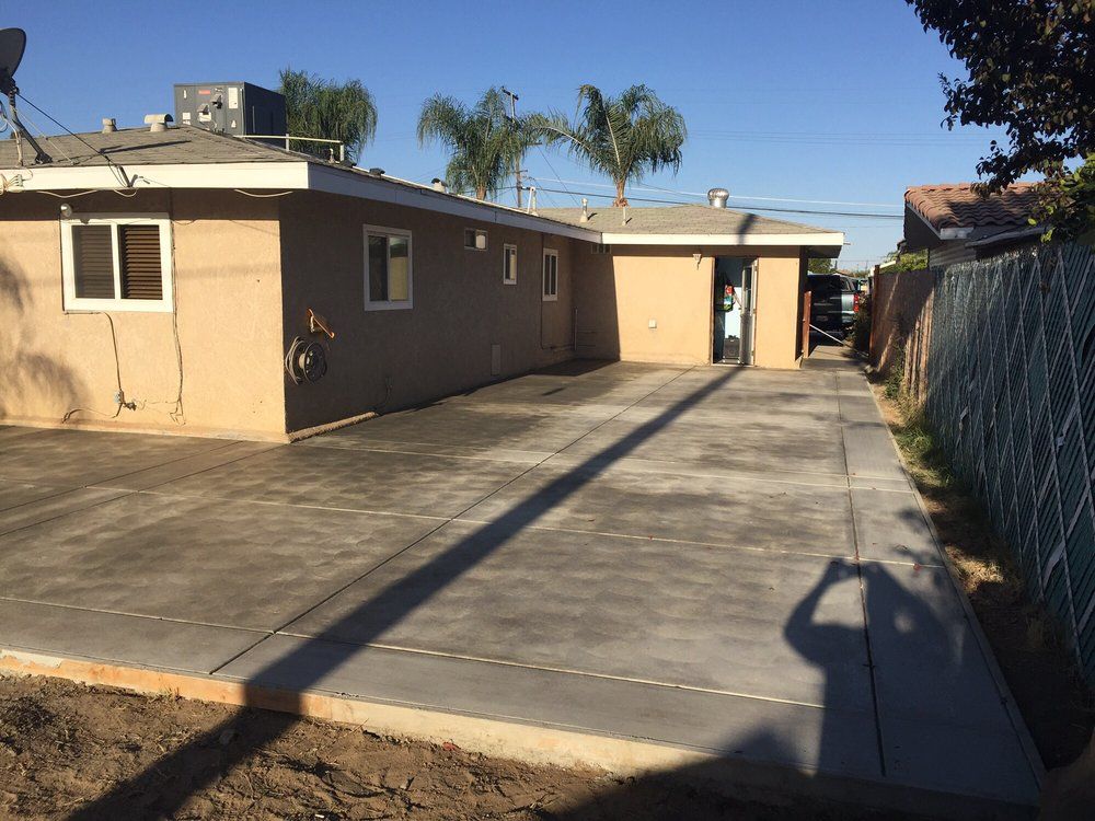 A house with a concrete driveway leading to it