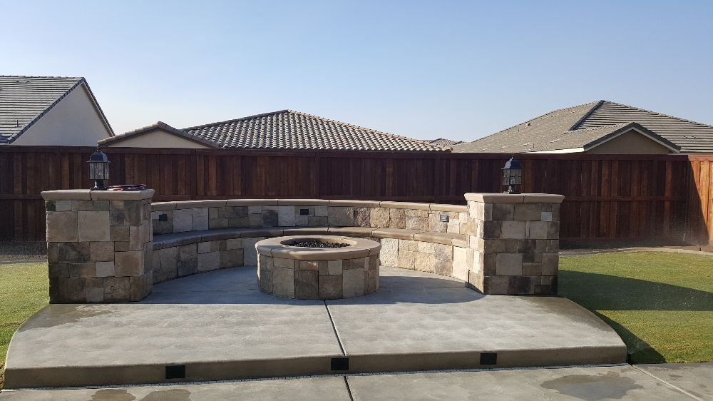 A fire pit in the backyard of a house