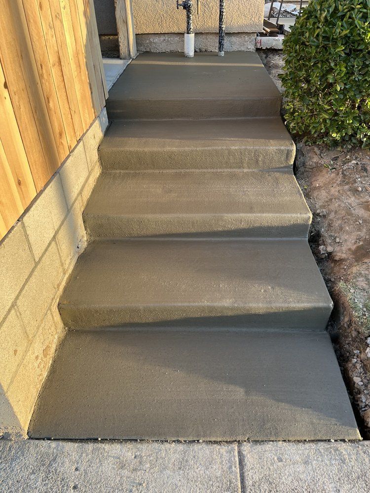A set of concrete steps leading up to a house.