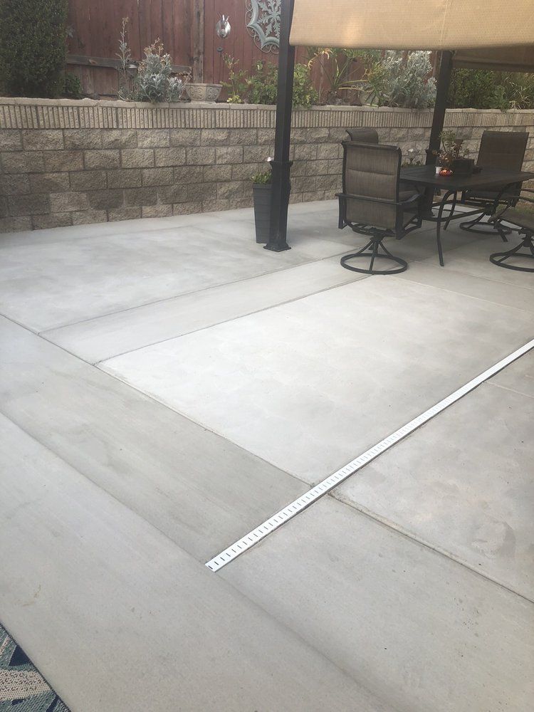 A patio with a table and chairs under a canopy.