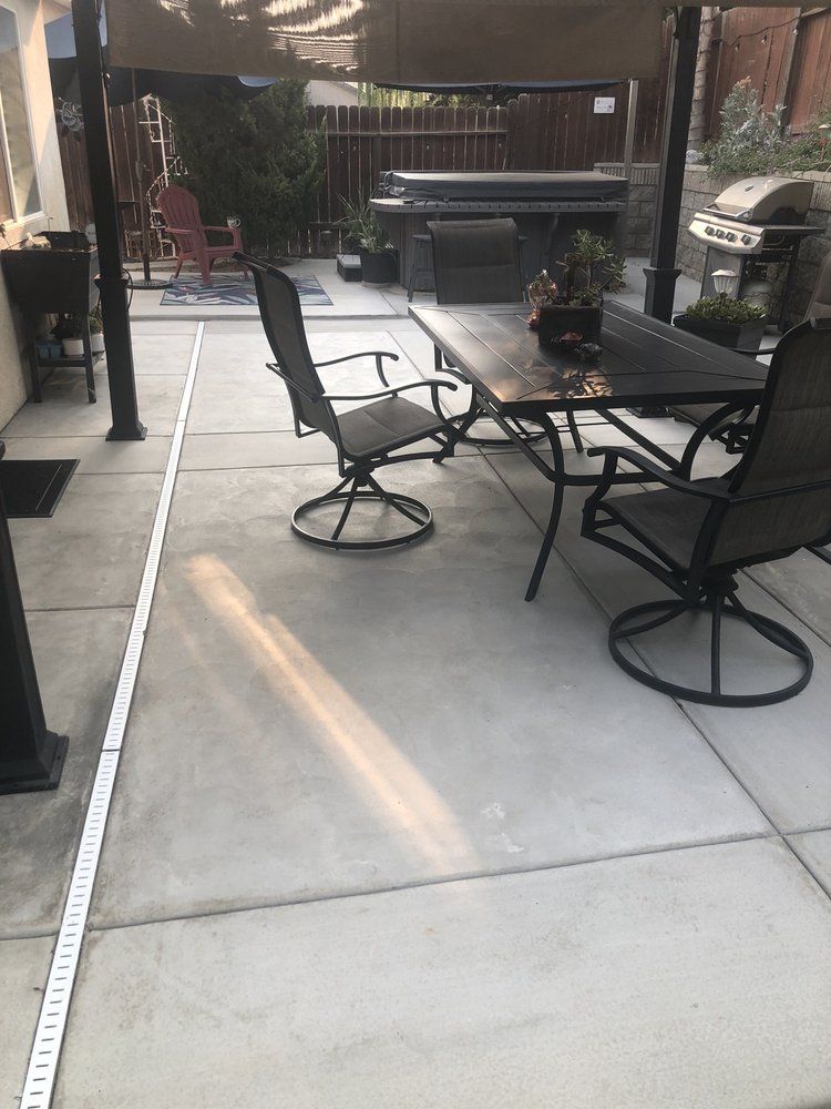 A patio with a table and chairs under a canopy.