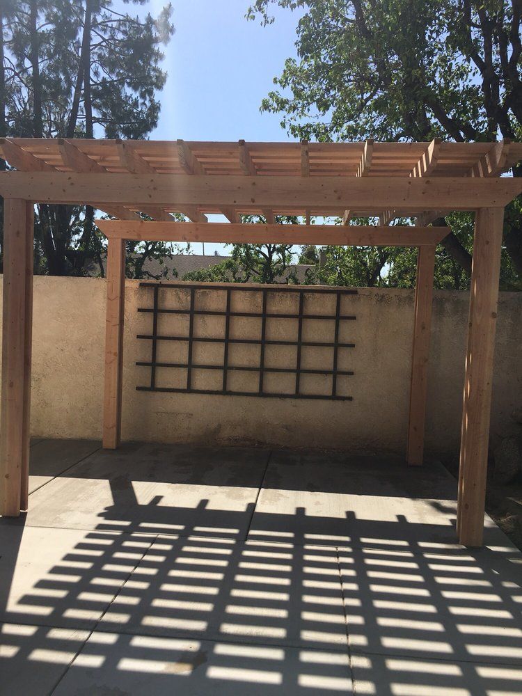 A wooden pergola with a trellis attached to it