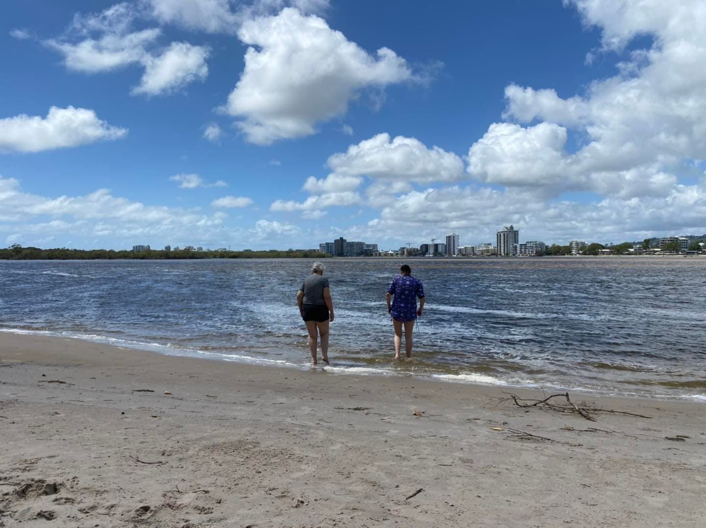 Two People Standing On A Beach Looking At The Water — Tailored Support Services Pty Ltd In Maroochydore, QLD