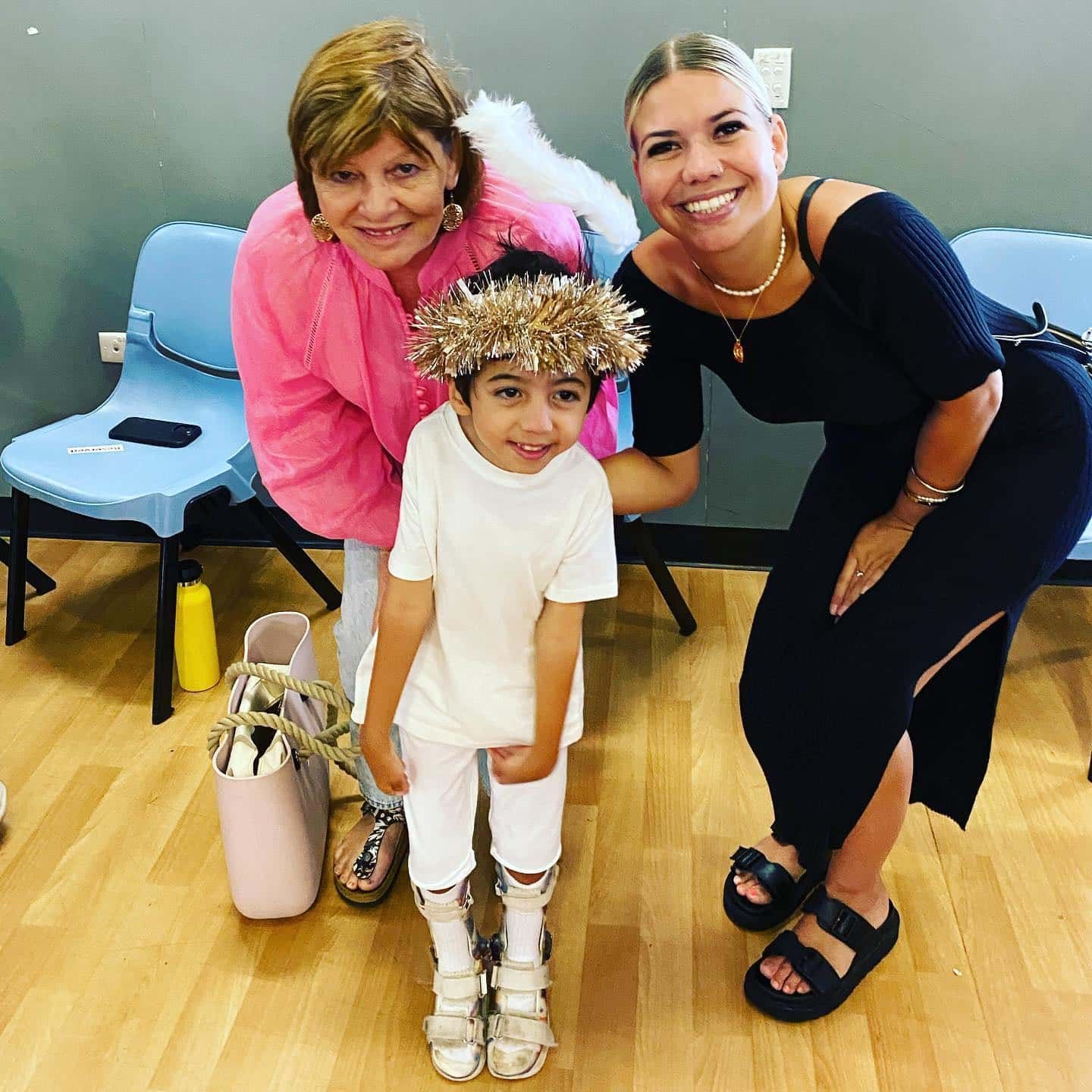 Three Women Are Posing For A Picture With A Little Boy In A Costume — Tailored Support Services Pty Ltd In Maroochydore, QLD