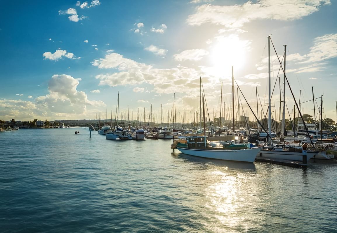 A Row Of Boats Are Docked In A Harbor On A Sunny Day — Tailored Support Services Pty Ltd In Maroochydore, QLD