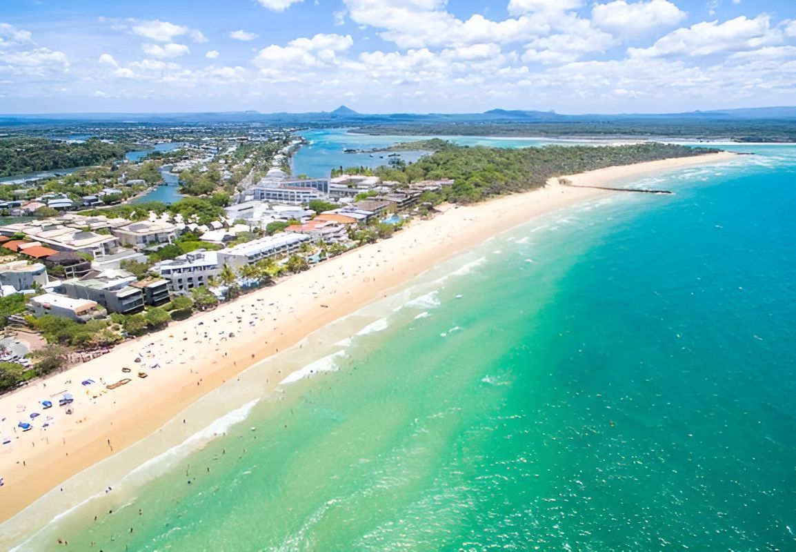 An Aerial View Of A Beach With A City In The Background — Tailored Support Services Pty Ltd In Noosa, QLD