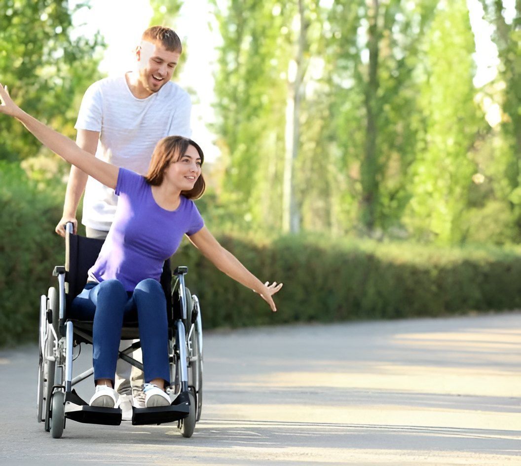 A Man Pushing The Wheelchair Of The Woman — Tailored Support Services Pty Ltd
 In Buderim, QLD