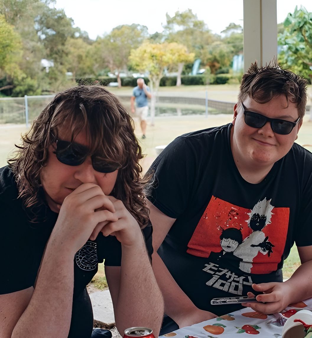 Two Men Sitting At A Table — Tailored Support Services Pty Ltd In Maroochydore, QLD