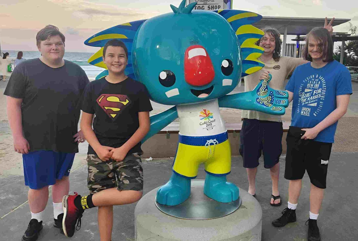 A Group Of Young Men Standing Next To A Statue Of A Koala — Tailored Support Services Pty Ltd
 In Buderim, QLD