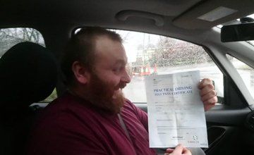 Man holding driving test pass