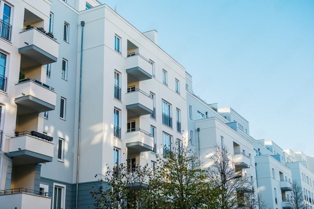 A row of apartment buildings with balconies on a sunny day.