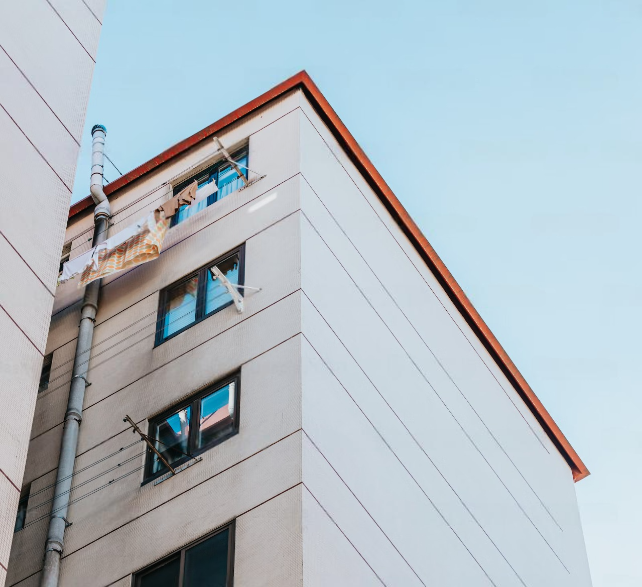 Looking up at a tall building with a blue sky in the background